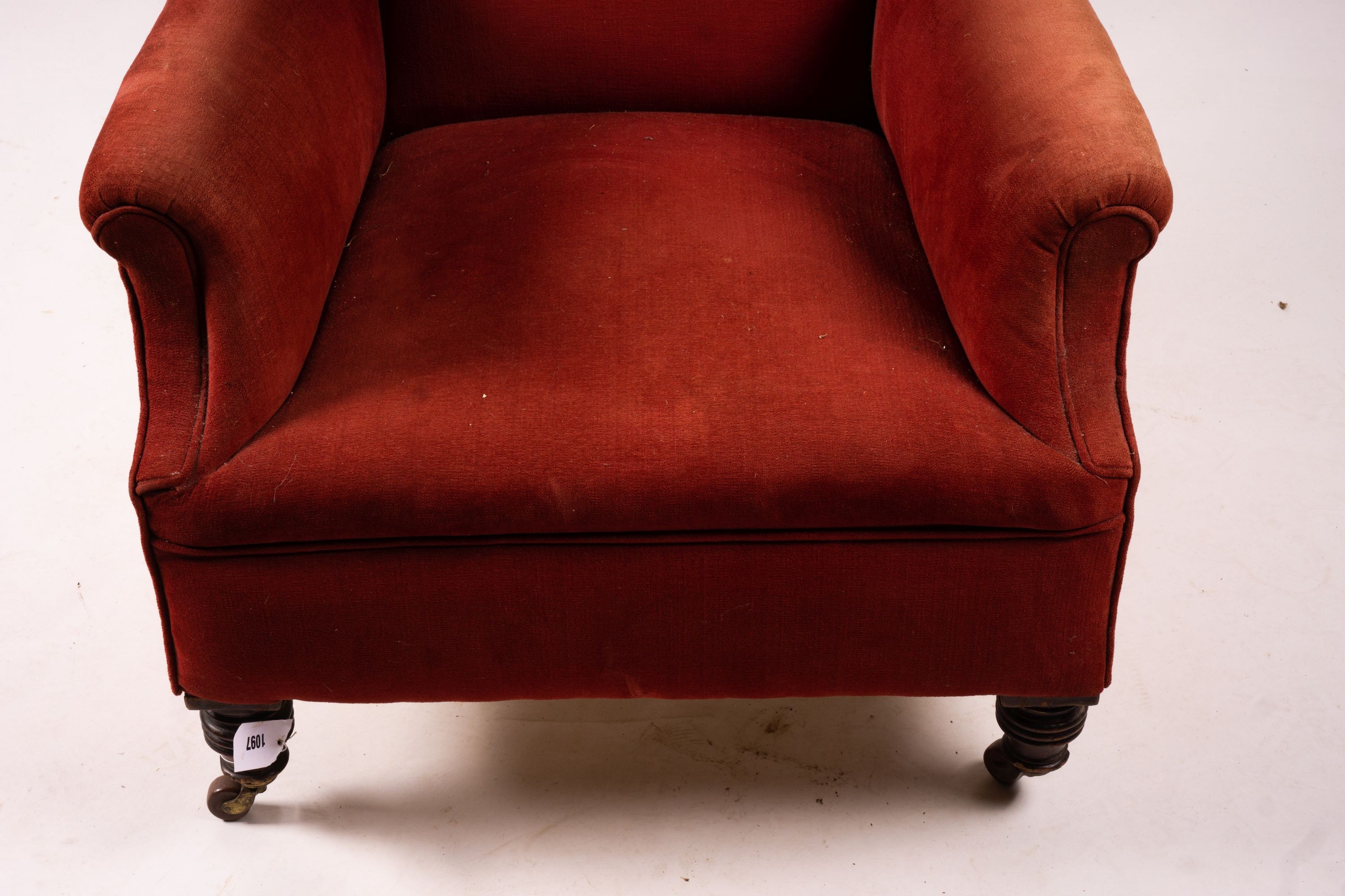 A late Victorian upholstered wing armchair, width 76cm, depth 70cm, height 100cm